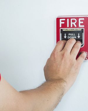 Personne activant le boîtier d'alarme incendie